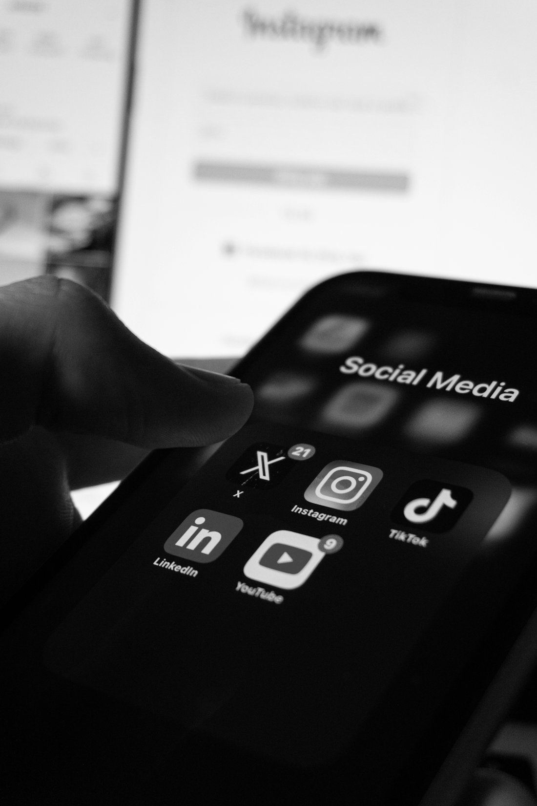 Hand holding a smartphone with social media apps